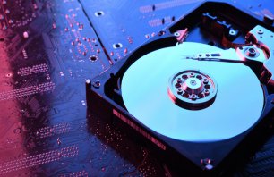 Computer Hard disk drives HDD , SSD on circuit board ,motherboard background. Close-up. With red-blue lighting.